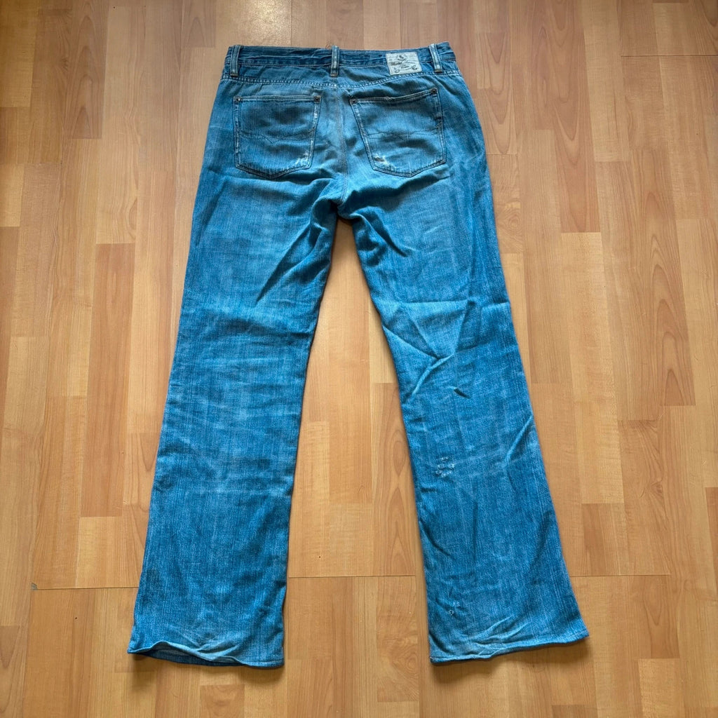 Ralph Lauren blue bootcut jeans with patchwork details and custom "RL" embroidery.