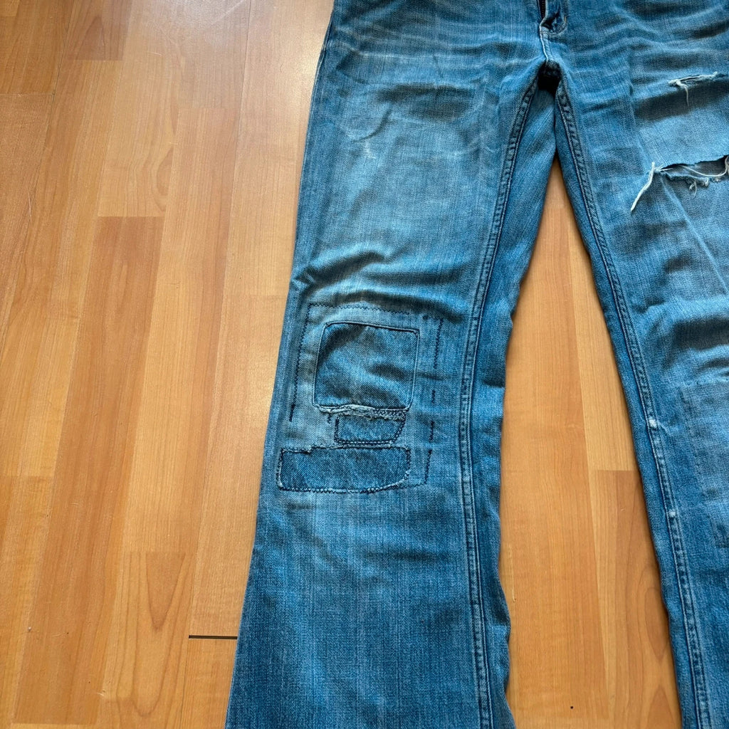 Ralph Lauren blue bootcut jeans with patchwork details and custom "RL" embroidery.