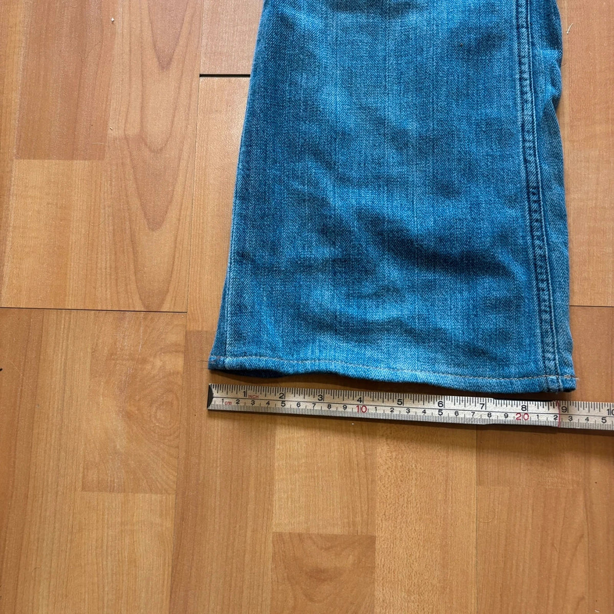 Ralph Lauren blue bootcut jeans with patchwork details and custom "RL" embroidery.