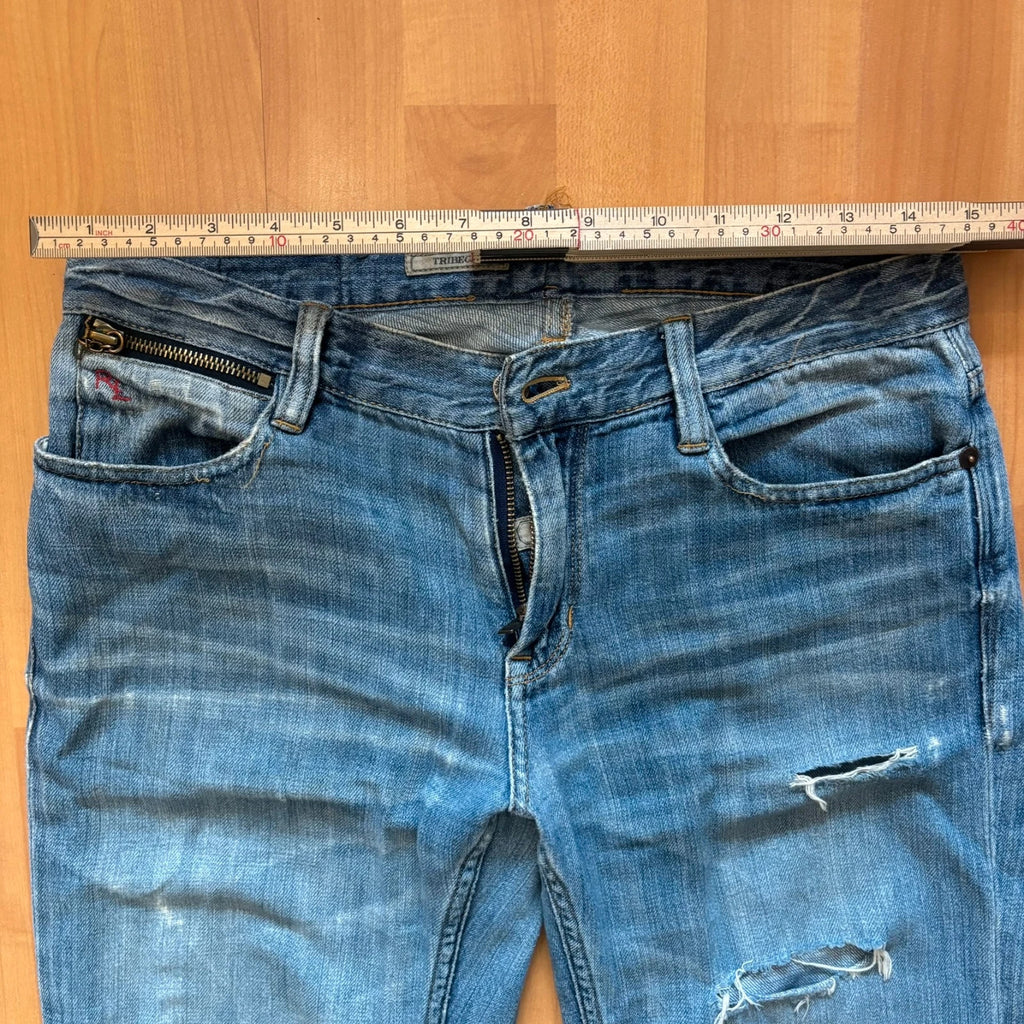 Ralph Lauren blue bootcut jeans with patchwork details and custom "RL" embroidery.