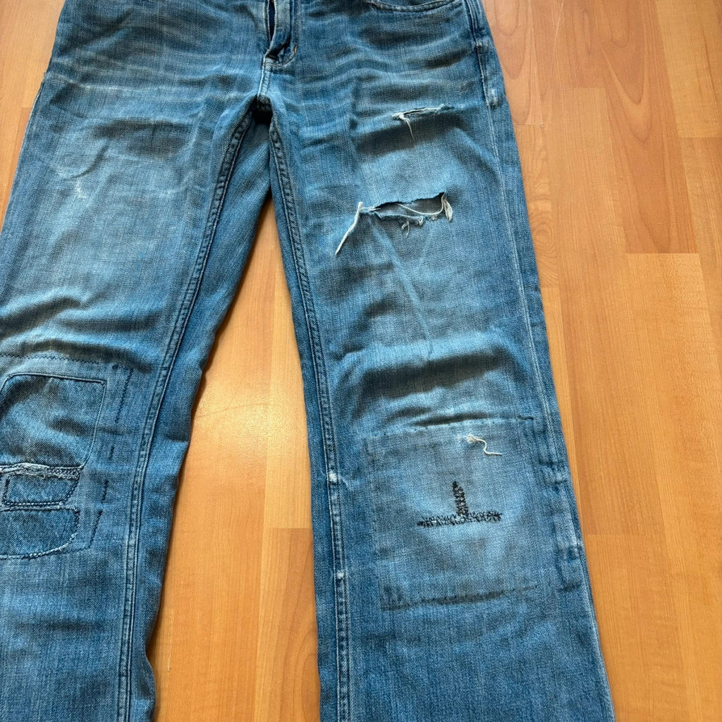 Ralph Lauren blue bootcut jeans with patchwork details and custom "RL" embroidery.
