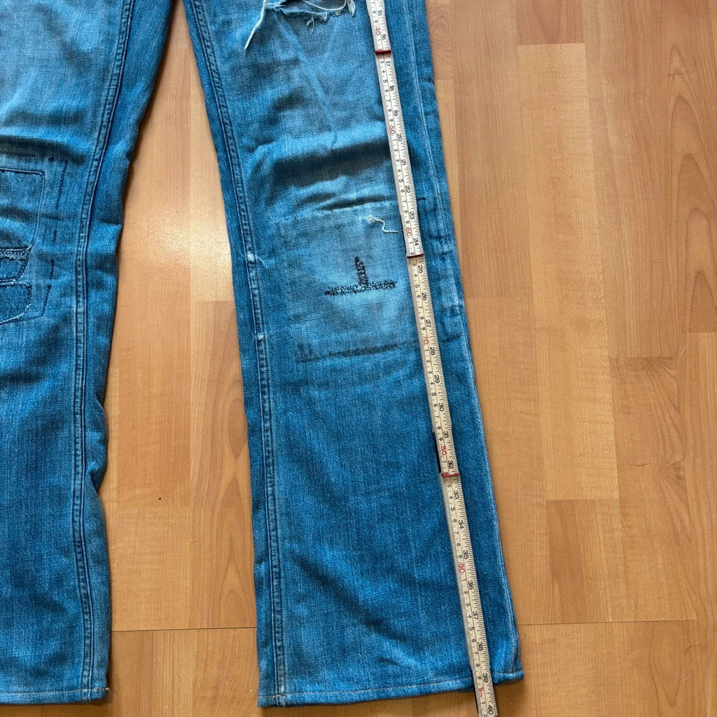 Ralph Lauren blue bootcut jeans with patchwork details and custom "RL" embroidery.