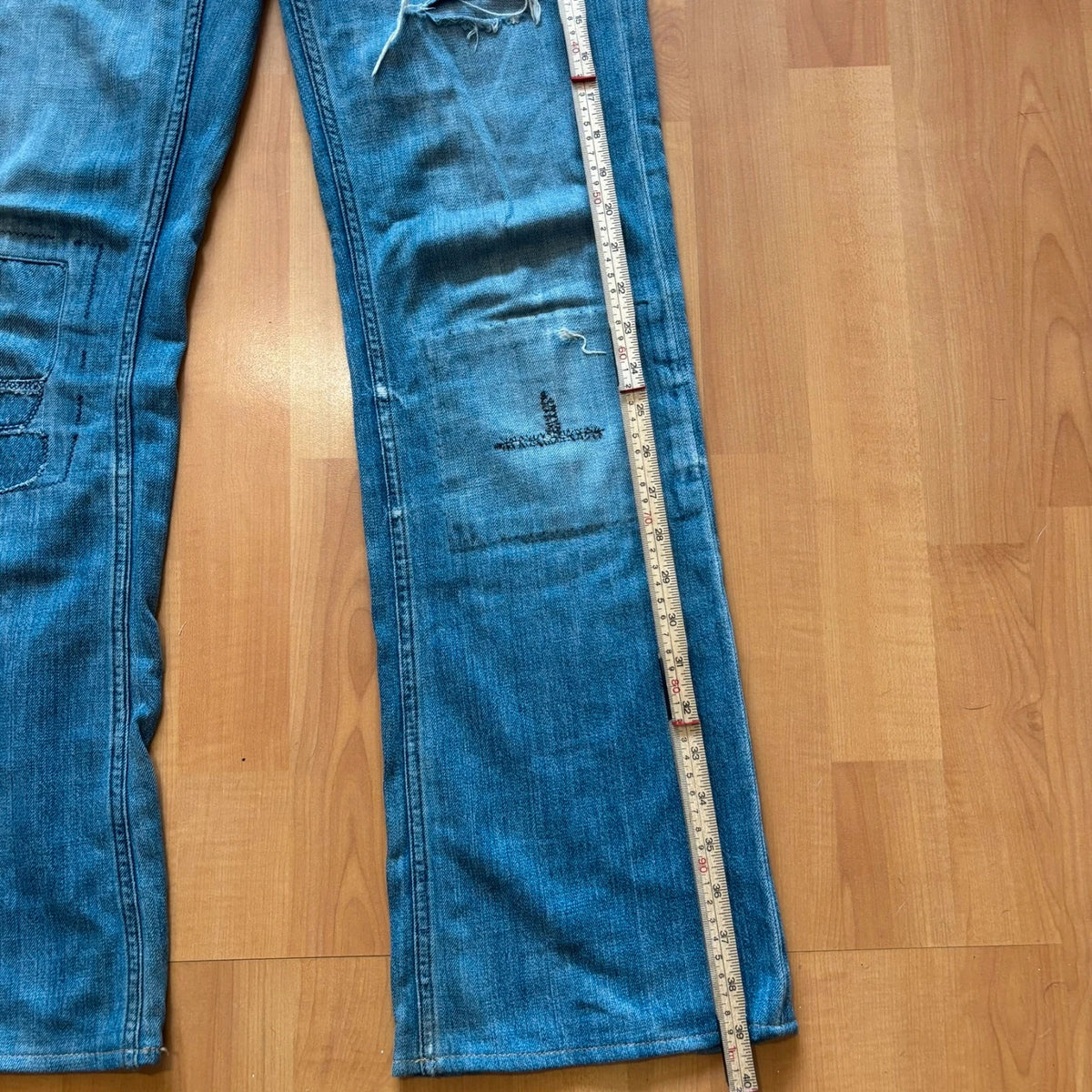 Ralph Lauren blue bootcut jeans with patchwork details and custom "RL" embroidery.