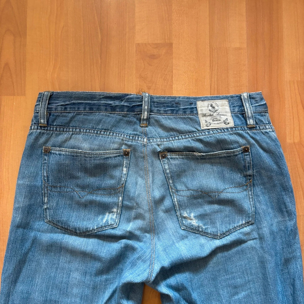 Ralph Lauren blue bootcut jeans with patchwork details and custom "RL" embroidery.