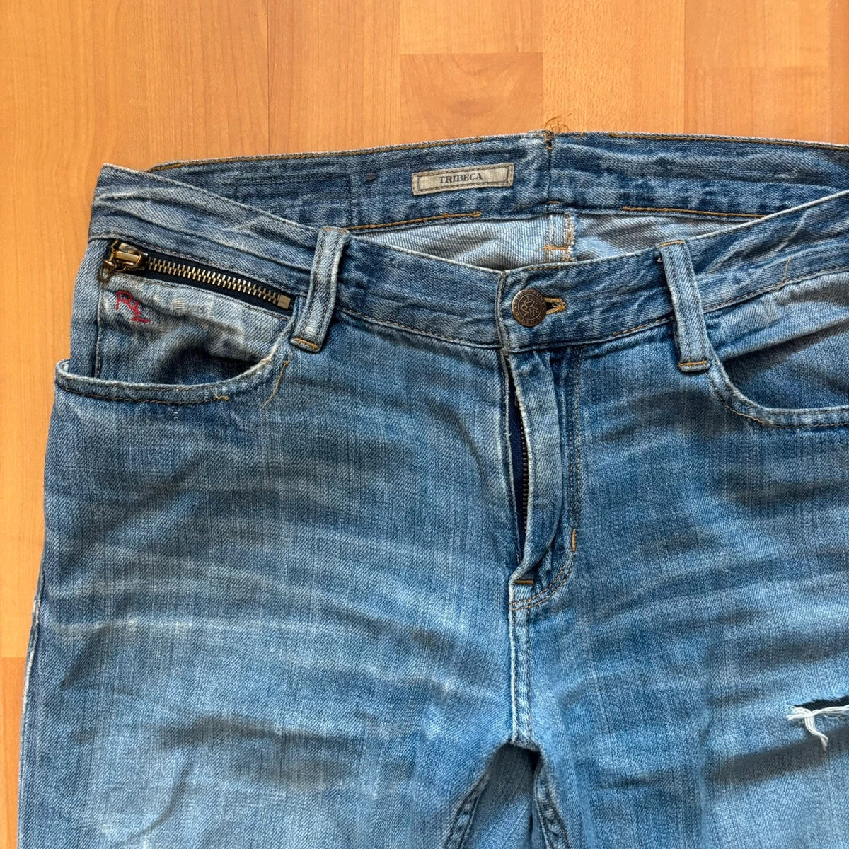 Ralph Lauren blue bootcut jeans with patchwork details and custom "RL" embroidery.