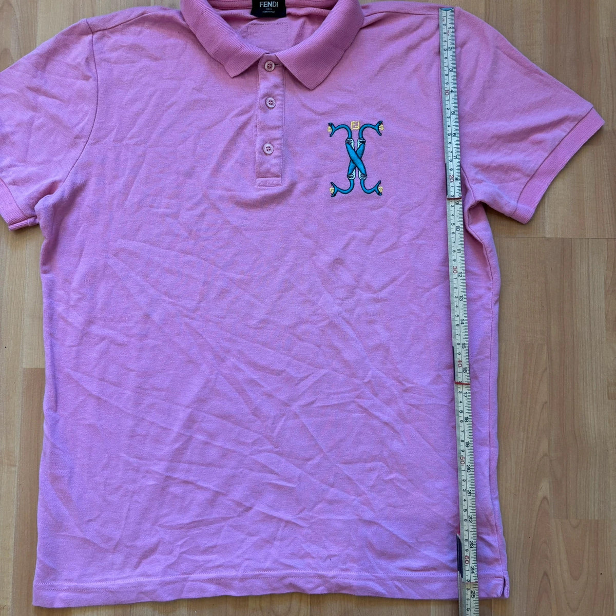 Fendi pink polo shirt with embroidered heart patch and branded buttons, cotton pique fabric.