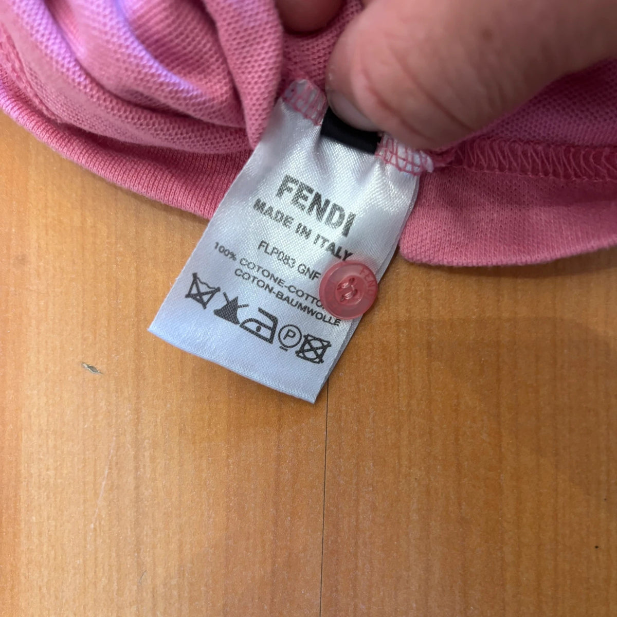 Fendi pink polo shirt with embroidered heart patch and branded buttons, cotton pique fabric.
