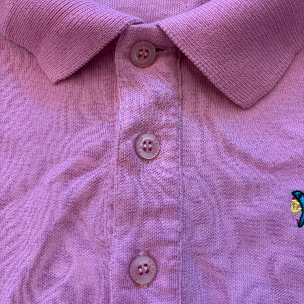Fendi pink polo shirt with embroidered heart patch and branded buttons, cotton pique fabric.