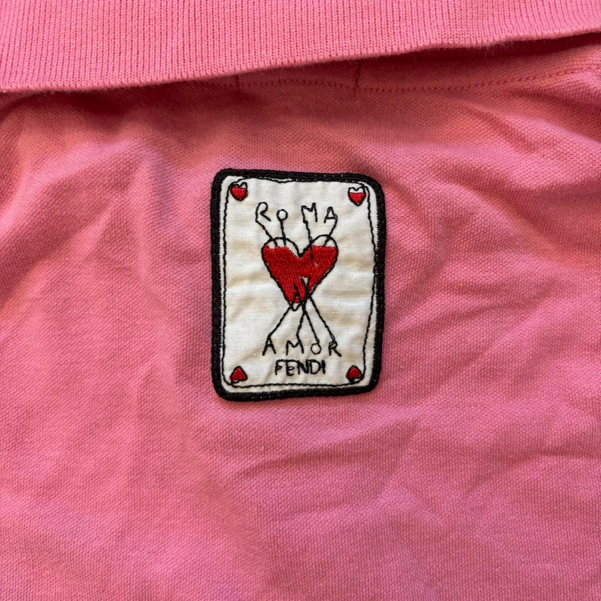 Fendi pink polo shirt with embroidered heart patch and branded buttons, cotton pique fabric.