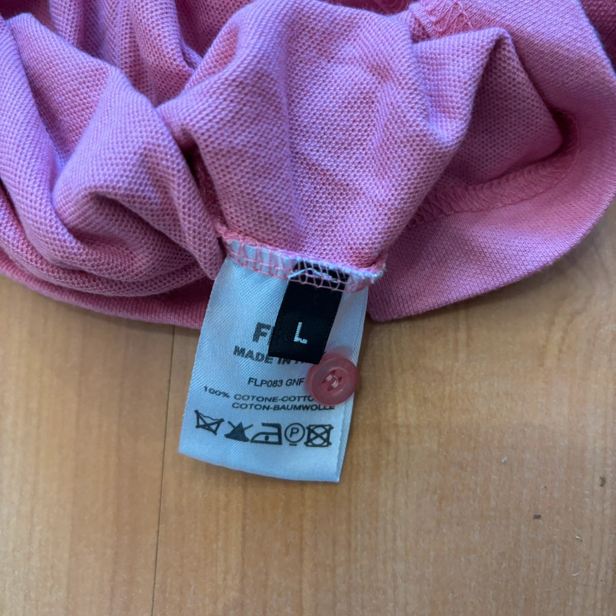 Fendi pink polo shirt with embroidered heart patch and branded buttons, cotton pique fabric.