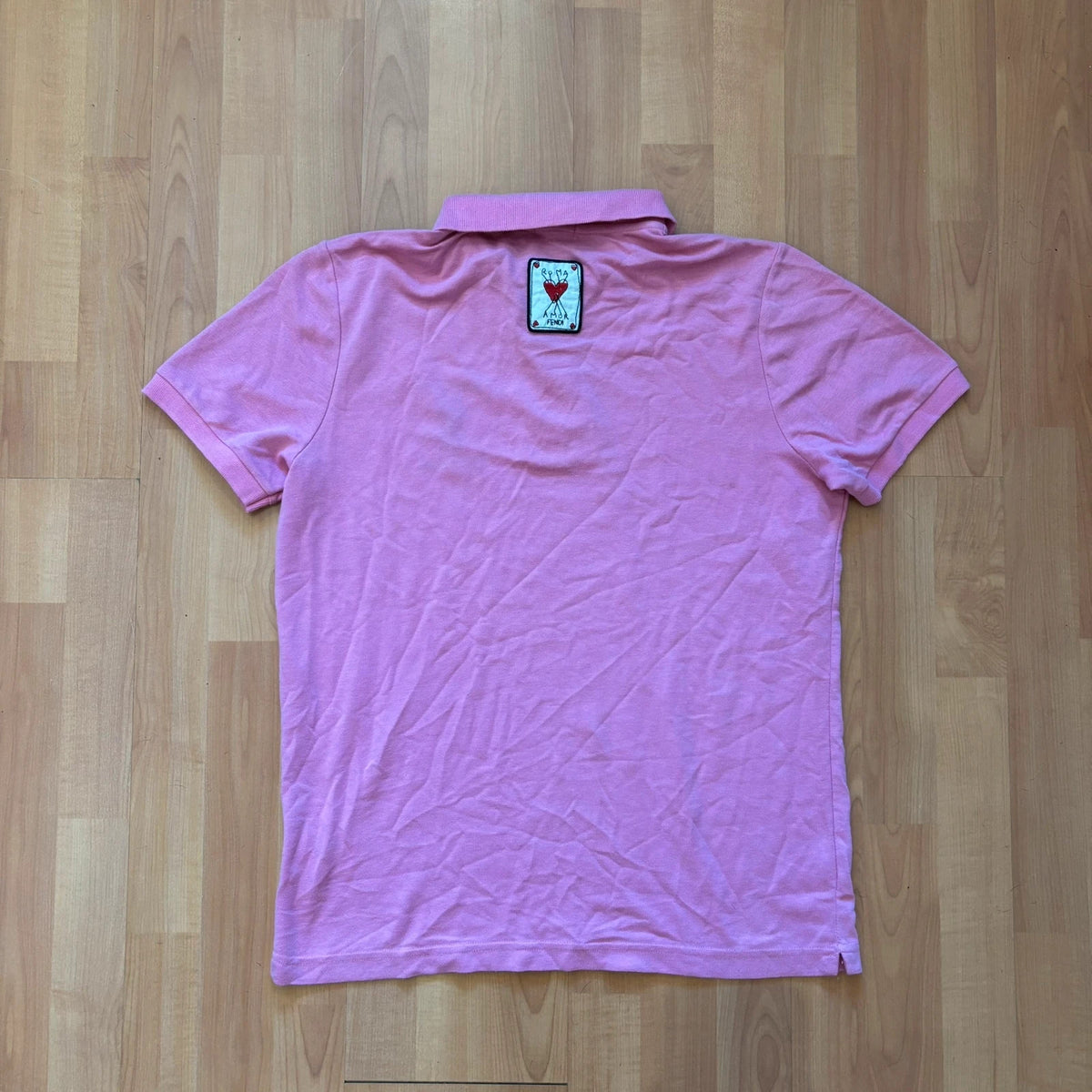 Fendi pink polo shirt with embroidered heart patch and branded buttons, cotton pique fabric.