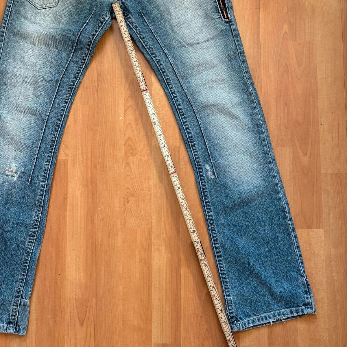 Daniele Alessandrini blue straight jeans with distressed details and front zip pockets.