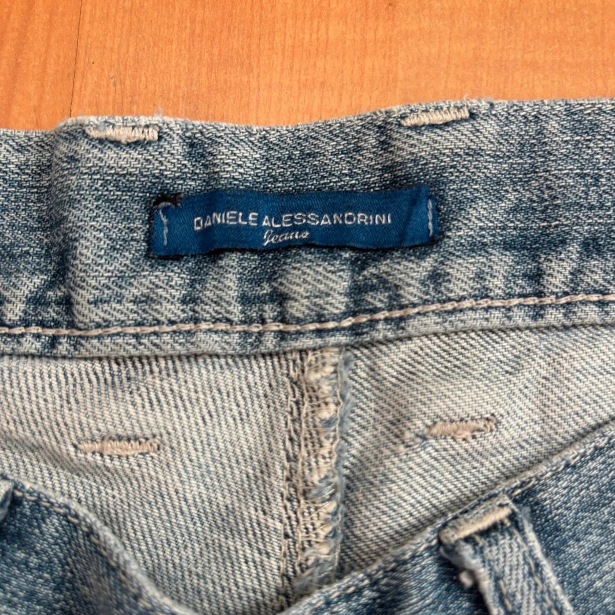 Daniele Alessandrini blue straight jeans with distressed details and front zip pockets.