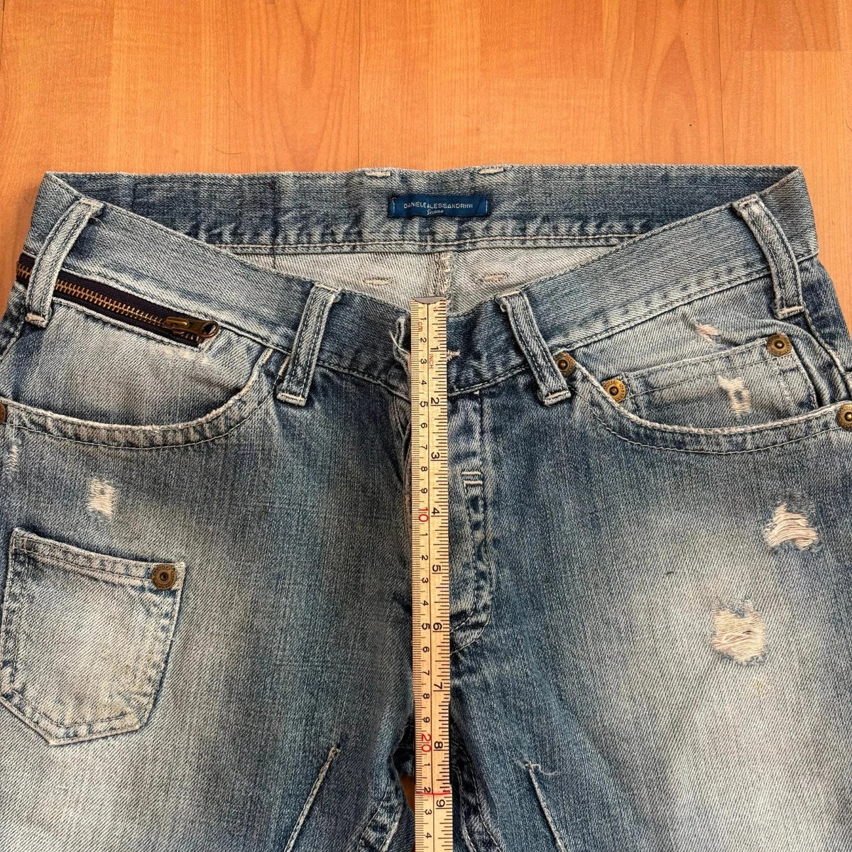 Daniele Alessandrini blue straight jeans with distressed details and front zip pockets.