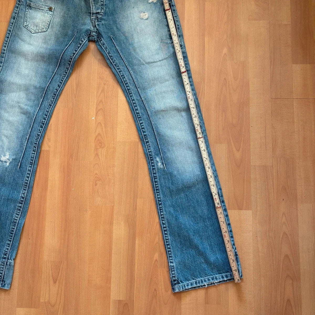Daniele Alessandrini blue straight jeans with distressed details and front zip pockets.