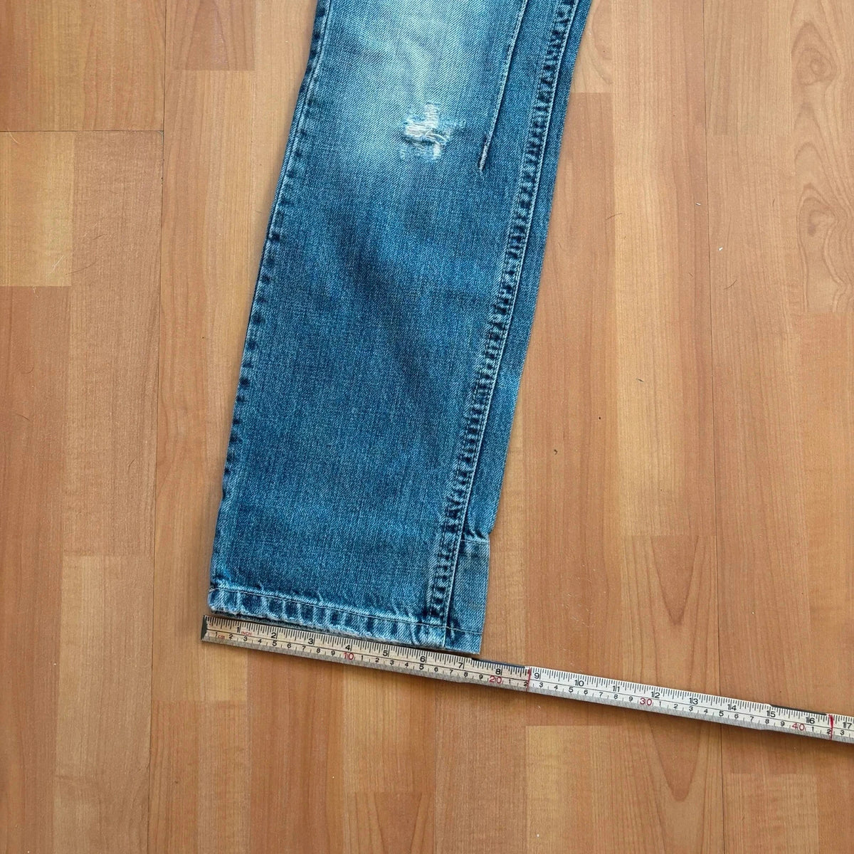 Daniele Alessandrini blue straight jeans with distressed details and front zip pockets.