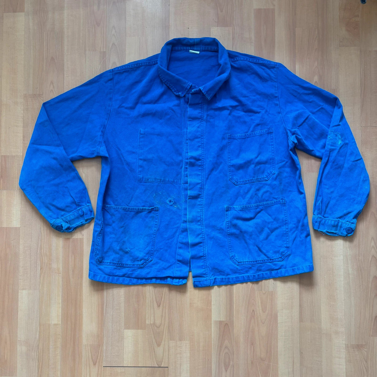 Vintage Dressing blue chore jacket, distressed cotton twill, multiple utility pockets, classic collar.