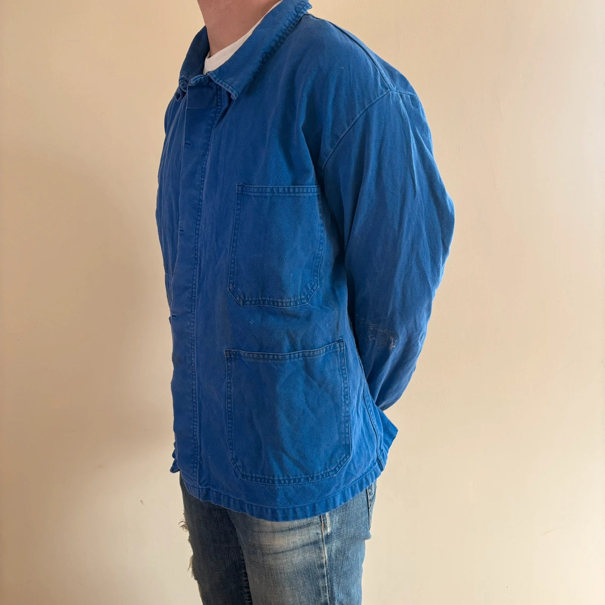 Vintage Dressing blue chore jacket, distressed cotton twill, multiple utility pockets, classic collar.
