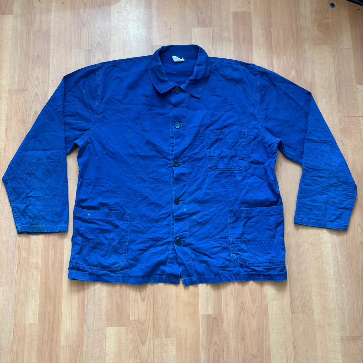Vintage Dressing blue chore coat with multiple patch pockets and rugged button closures.