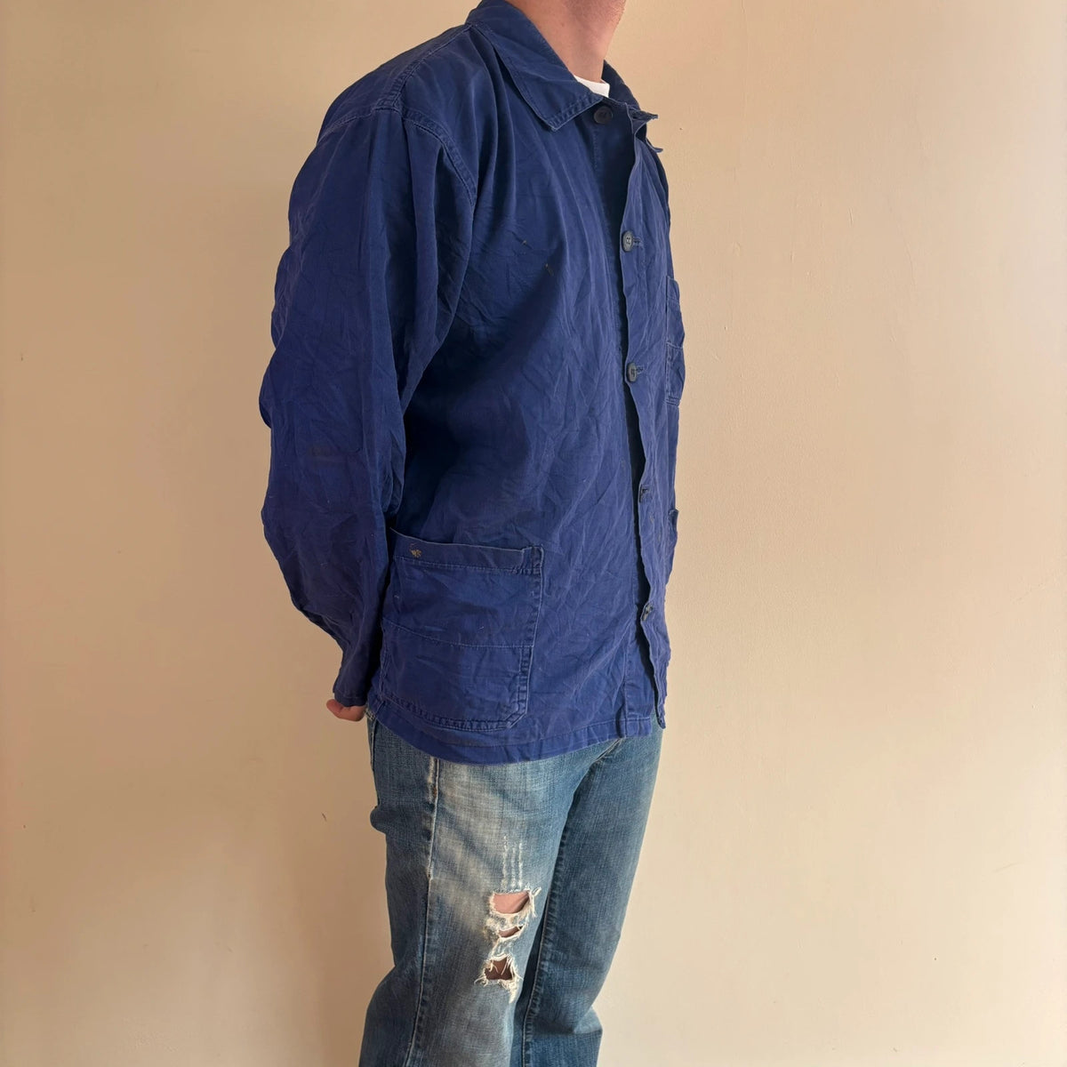 Vintage Dressing blue chore coat with multiple patch pockets and rugged button closures.