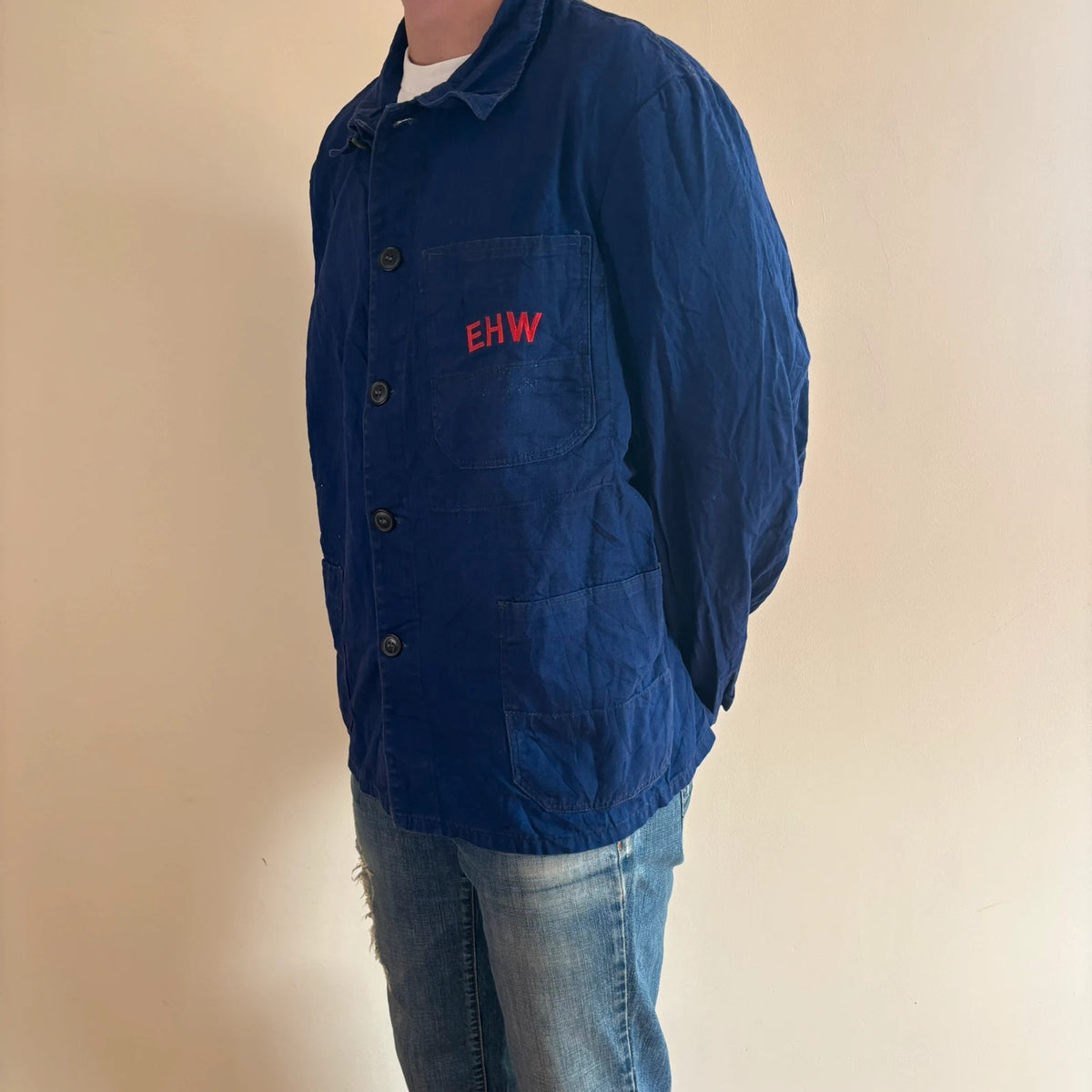 Vintage Dressing navy chore coat with red "EHW" embroidery and classic collar.