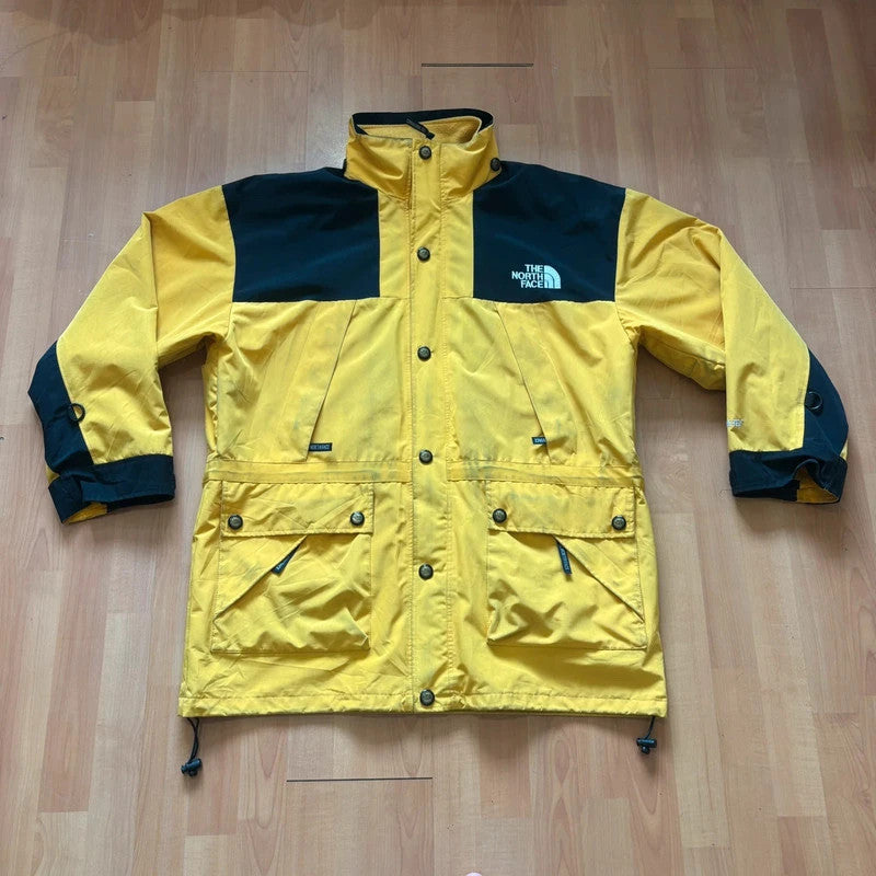 The North Face 2-in-1 jacket yellow black color block design with embroidered logos.