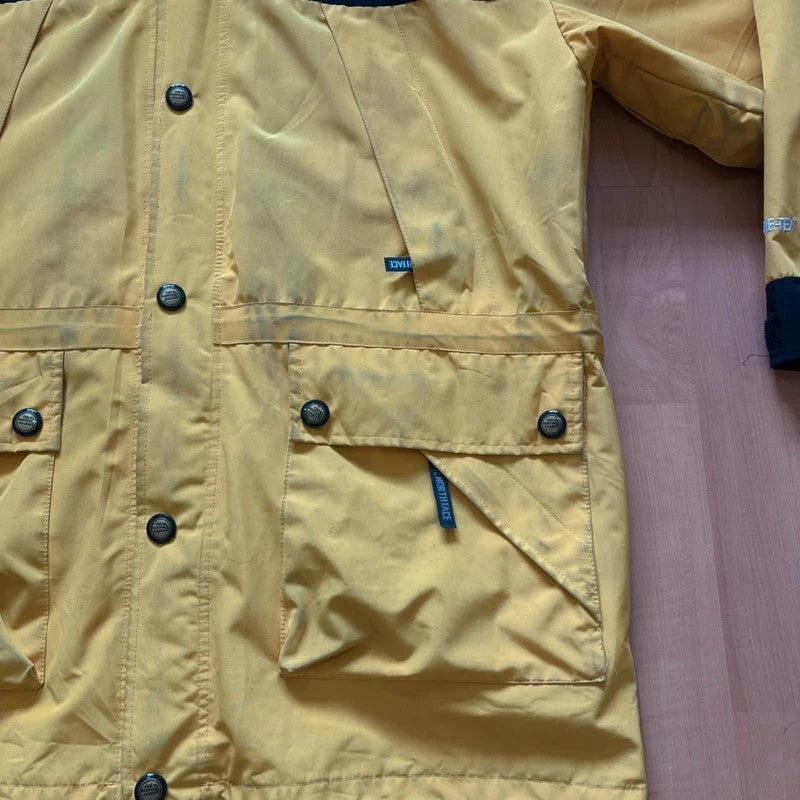 The North Face 2-in-1 jacket yellow black color block design with embroidered logos.