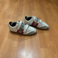 Bikkembergs red and white trainers with velcro straps, perforated leather, and suede accents.