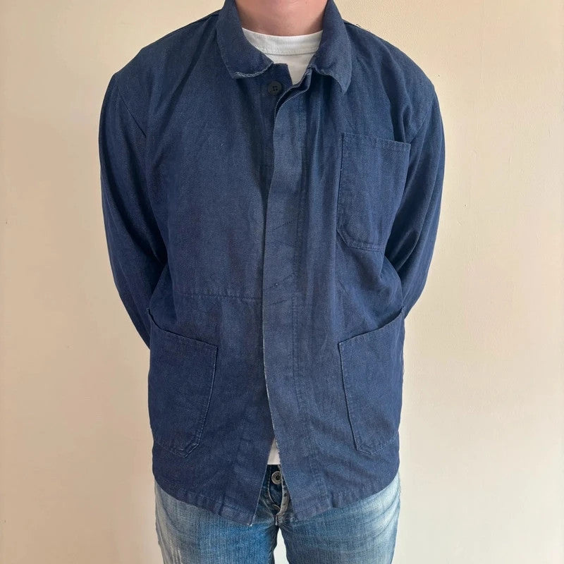 Vintage Dressing blue chore jacket with pointed collar, button front, and utility patch pockets.