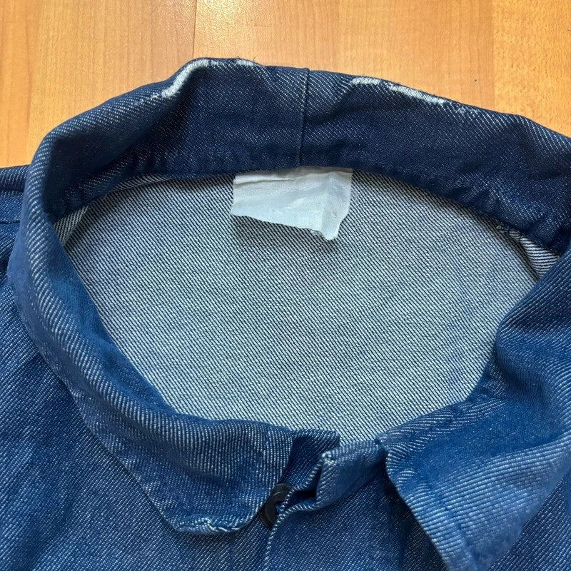 Vintage Dressing blue chore jacket with pointed collar, button front, and utility patch pockets.
