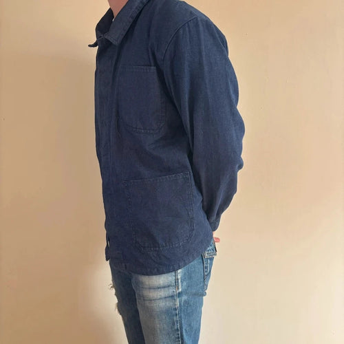 Vintage Dressing blue chore jacket with pointed collar, button front, and utility patch pockets.