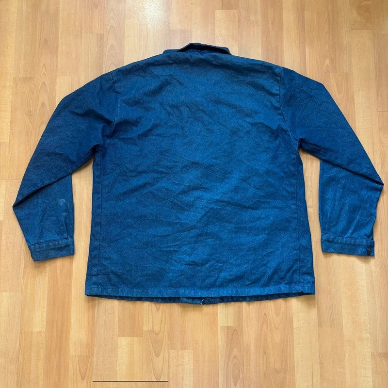 Vintage Dressing blue chore jacket with pointed collar, button front, and utility patch pockets.