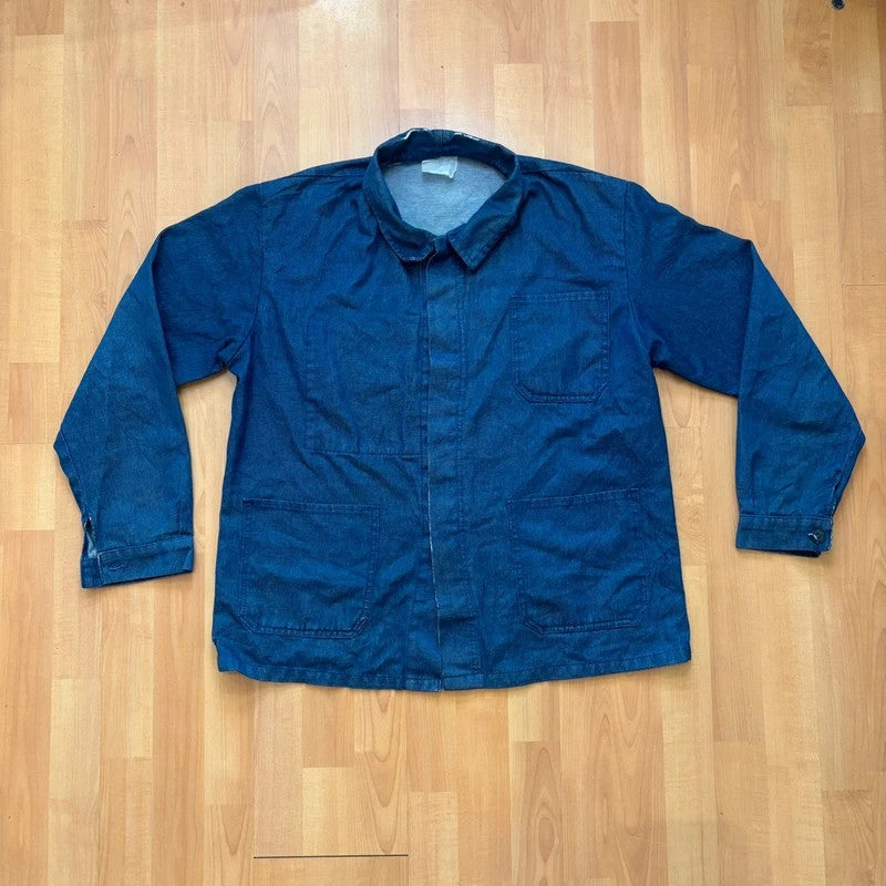 Vintage Dressing blue chore jacket with pointed collar, button front, and utility patch pockets.