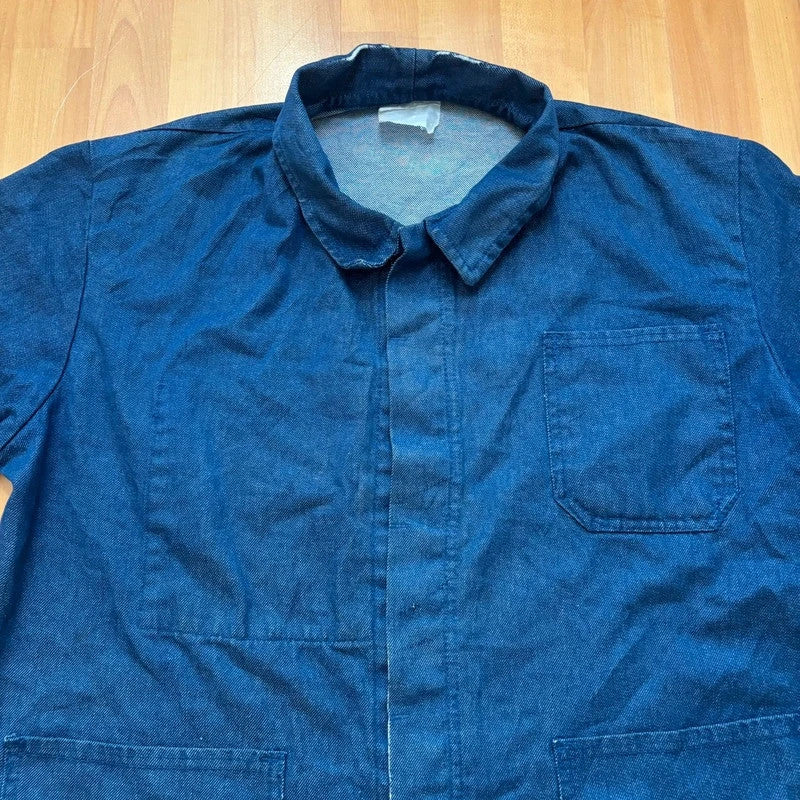 Vintage Dressing blue chore jacket with pointed collar, button front, and utility patch pockets.
