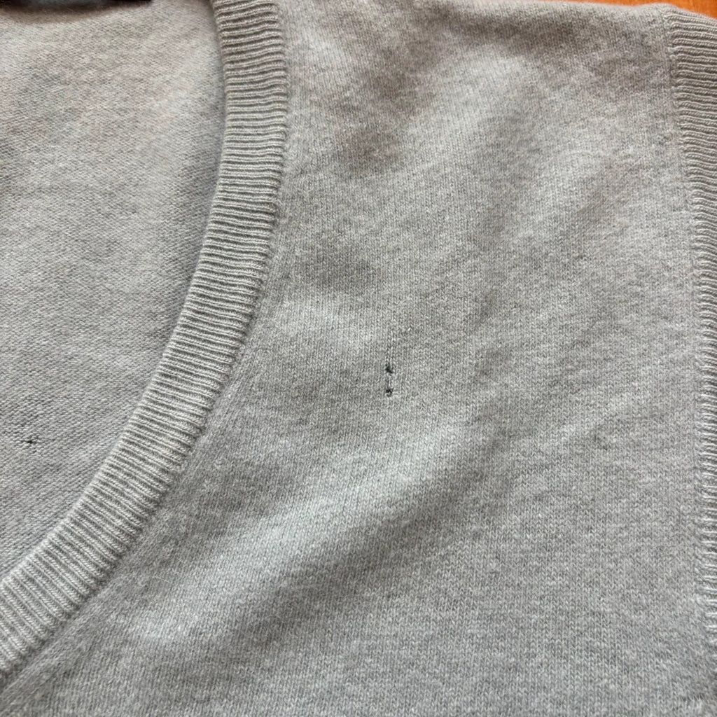 Yves Saint Laurent blue knitted vest with embroidered logo and ribbed detailing.