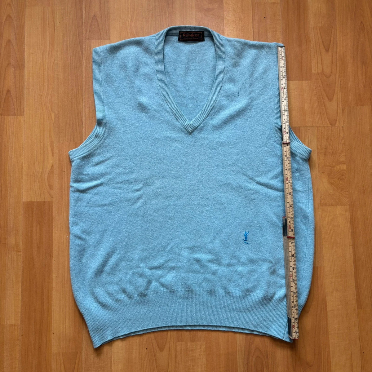 Yves Saint Laurent blue knitted vest with embroidered logo and ribbed detailing.