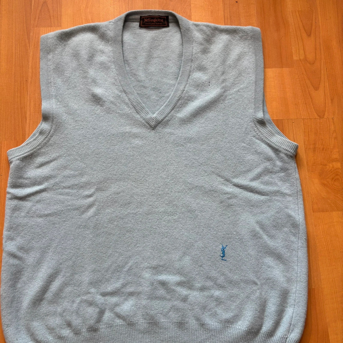 Yves Saint Laurent blue knitted vest with embroidered logo and ribbed detailing.