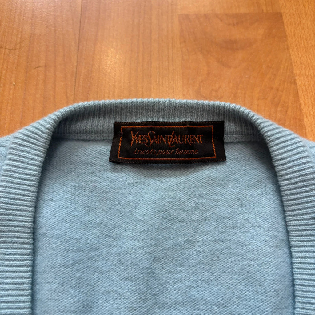 Yves Saint Laurent blue knitted vest with embroidered logo and ribbed detailing.