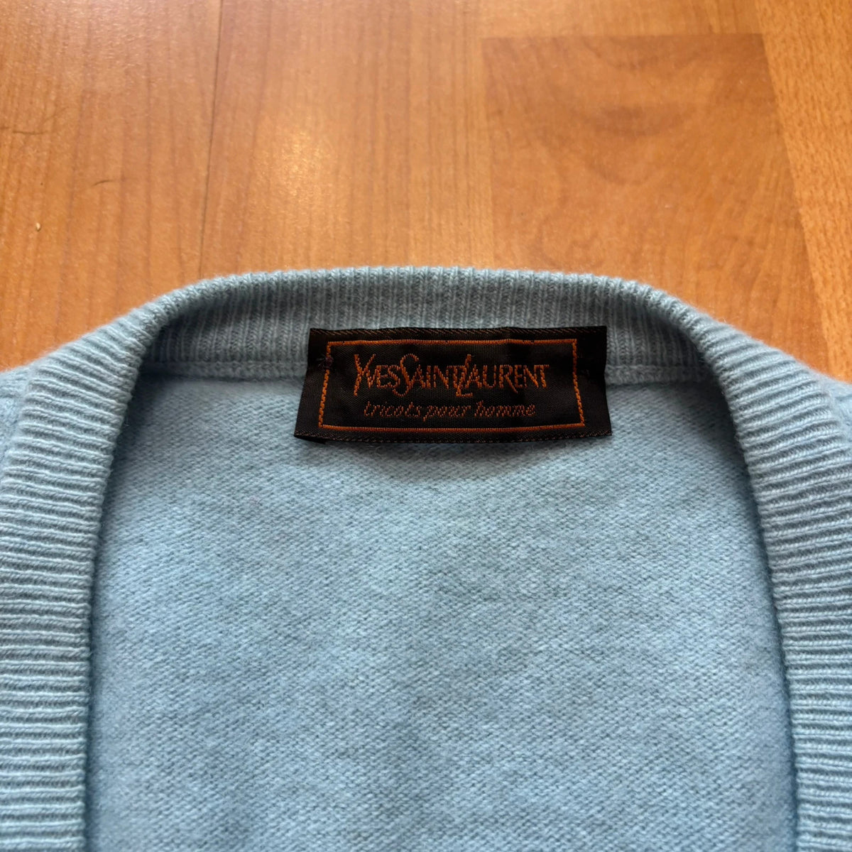 Yves Saint Laurent blue knitted vest with embroidered logo and ribbed detailing.