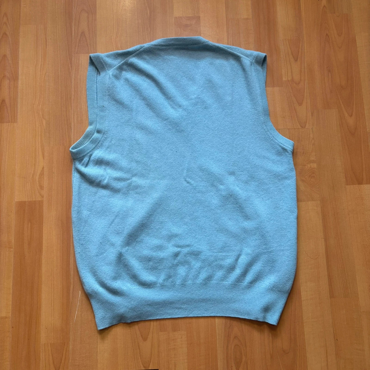 Yves Saint Laurent blue knitted vest with embroidered logo and ribbed detailing.