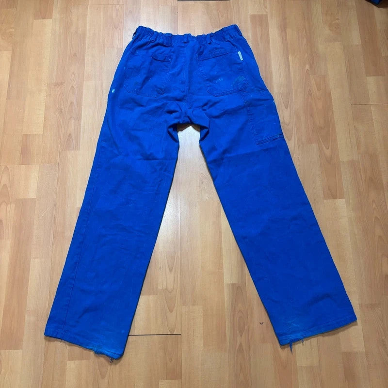 Vintage Dressing blue wide-leg trousers with paint splatters and elasticated waistband.