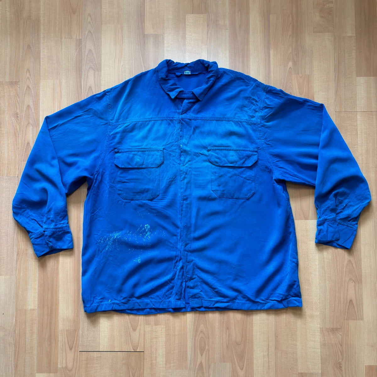 Vintage Dressing blue workwear jacket with snap-button closures and "Steel-Tec" back patch.