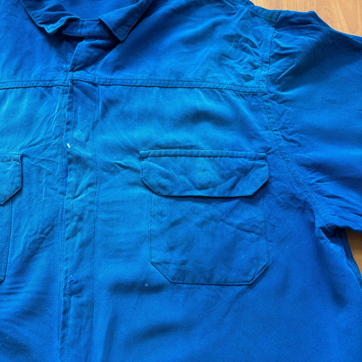 Vintage Dressing blue workwear jacket with snap-button closures and "Steel-Tec" back patch.