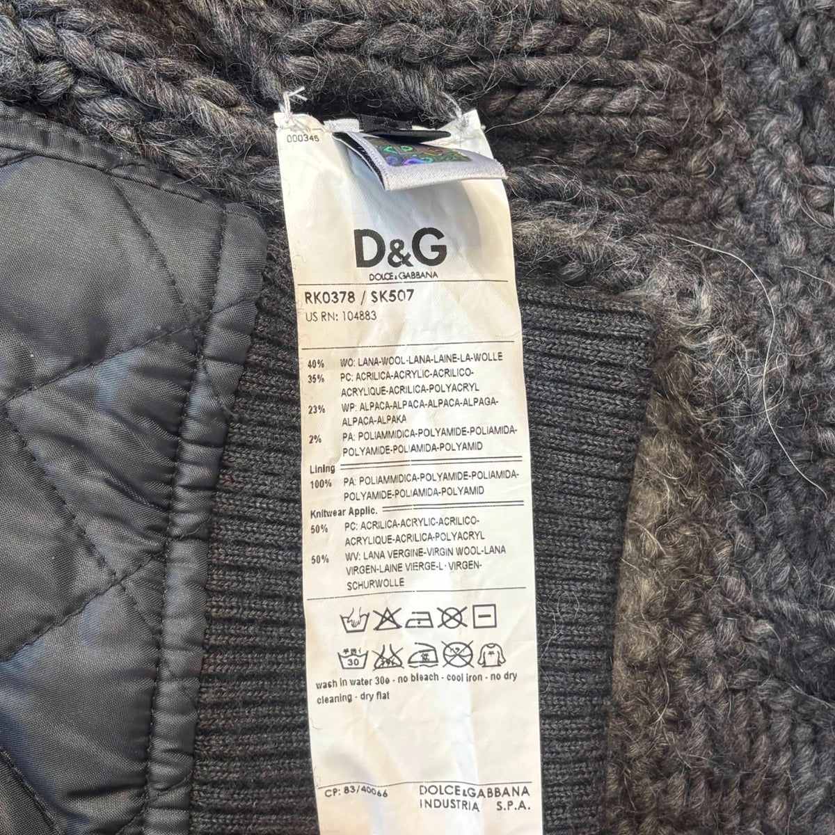 Dolce & Gabbana black and grey chunky knit cardigan with removable quilted bomber jacket.