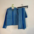 DKNY blue fleece tracksuit set with logo branding and side stripe details.