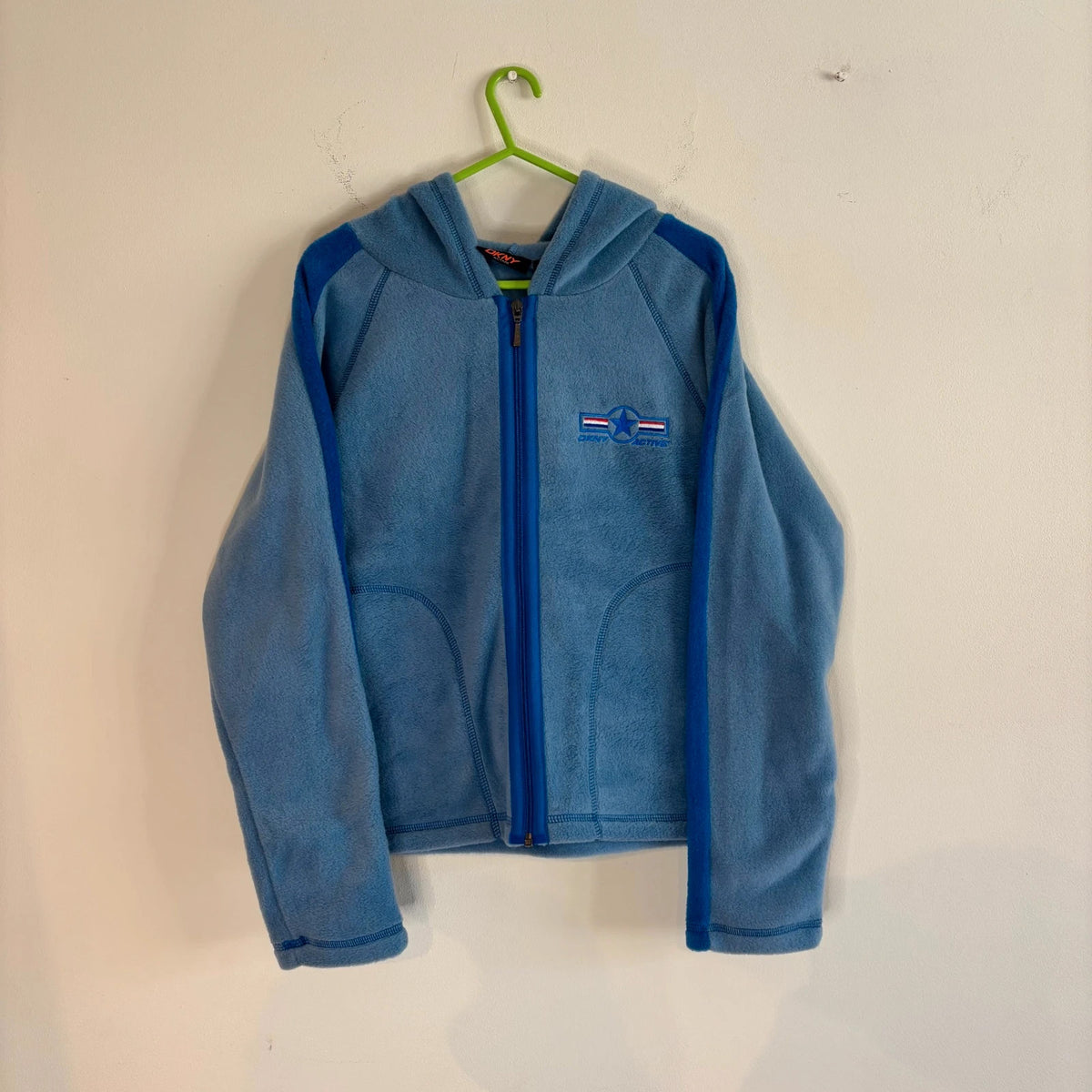 DKNY blue fleece tracksuit set with logo branding and side stripe details.