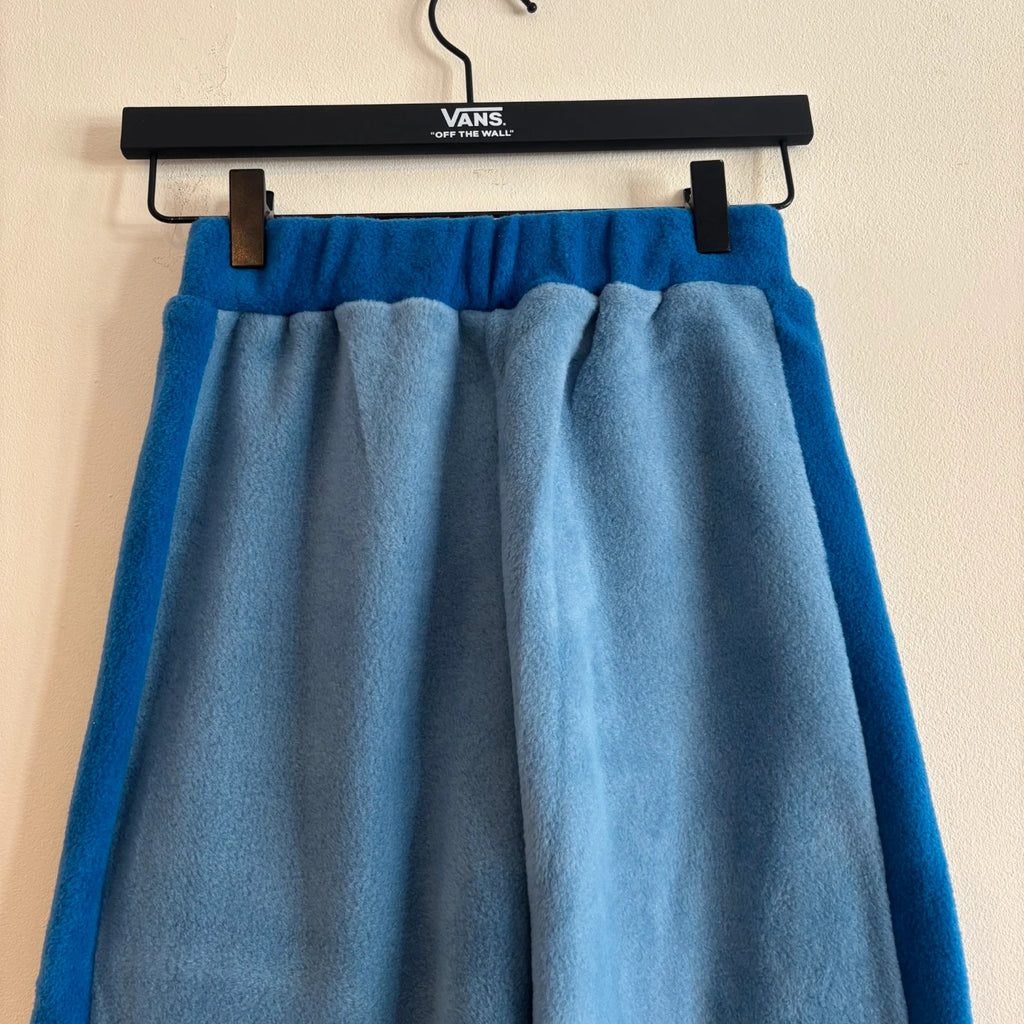 DKNY blue fleece tracksuit set with logo branding and side stripe details.
