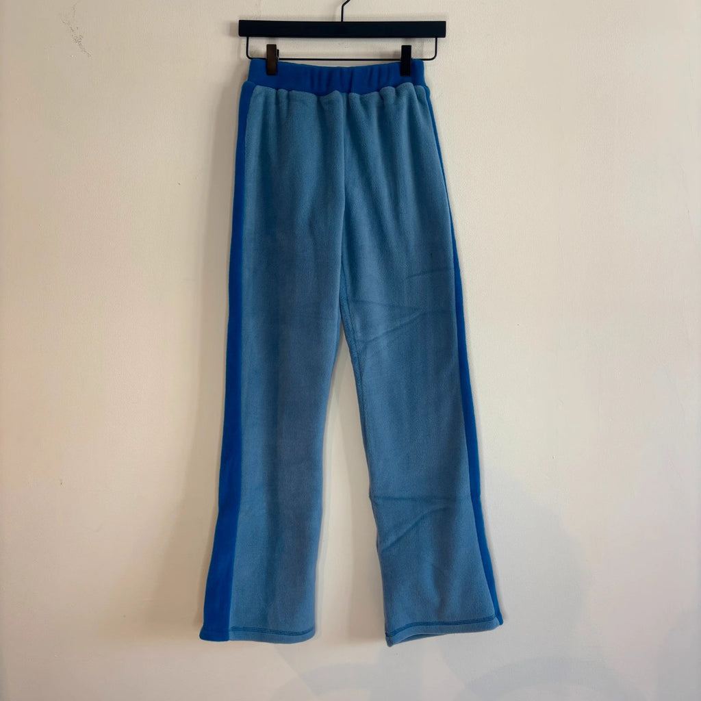 DKNY blue fleece tracksuit set with logo branding and side stripe details.