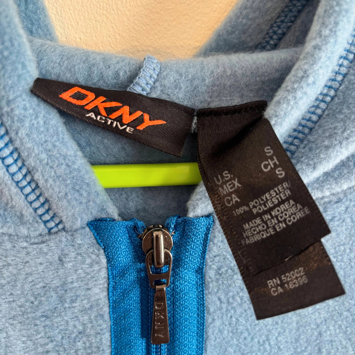DKNY blue fleece tracksuit set with logo branding and side stripe details.
