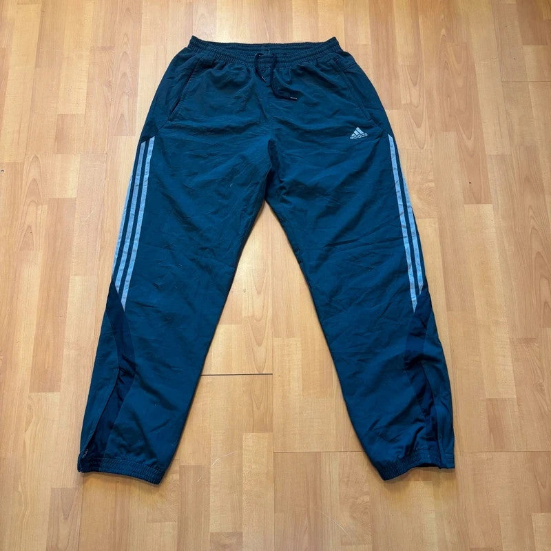 Adidas grey joggers with reflective three-stripe detailing and adjustable drawstring waist.